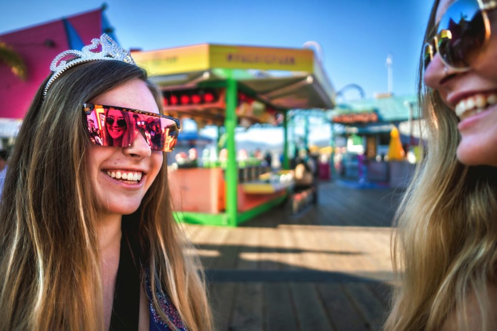 Girls smiling in sunglasses inside Pacific Park