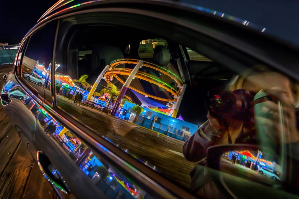 Reflection of rollercoaster in car window