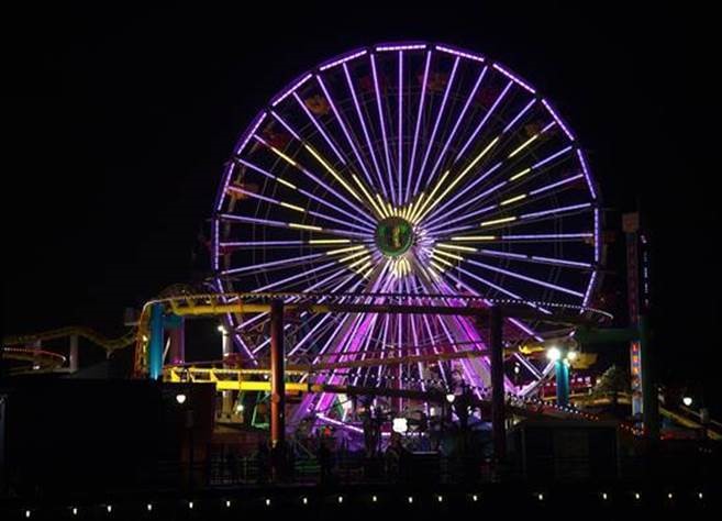 The Santa Monica Pier Ferris wheel lit in Purple and Gold for Fox's The Masked Singer
