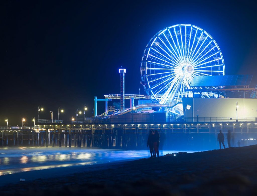 The Pacific Wheel shines blue light over Santa Monica State Beach as part of a city-wide memorial for victims of Covid19 | Phot by @edwardgradart