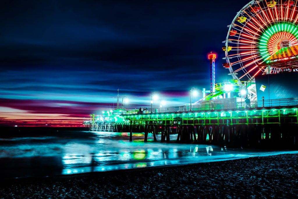 The red and green colors of the flag of Bangladesh shine on the Pacific Wheel in Santa Monica | Photo by @93nezhad