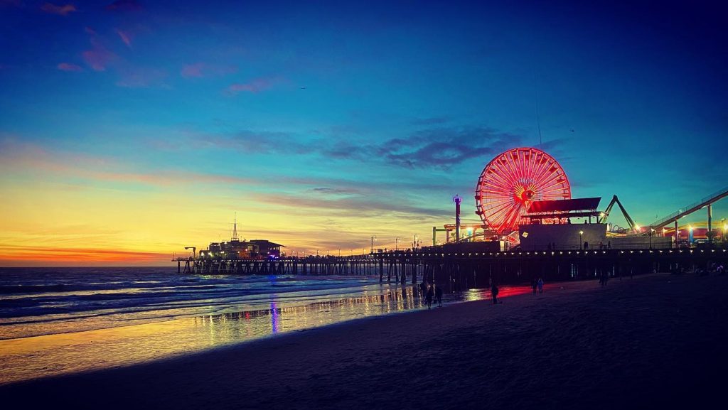 The Pacific Wheel at the Santa Monica Pier lit red at sunset in observance of Asian American Pacific Islander Month