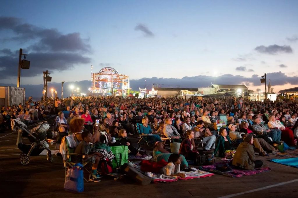 Guest seated outside on the Santa Monica Pier for a free LA Opera at the Beach perfformance