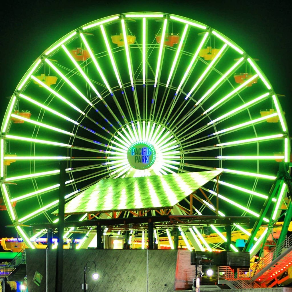 The Ferris wheel on the Santa Monica Pier lit bright green - Photo by @el_pep562
