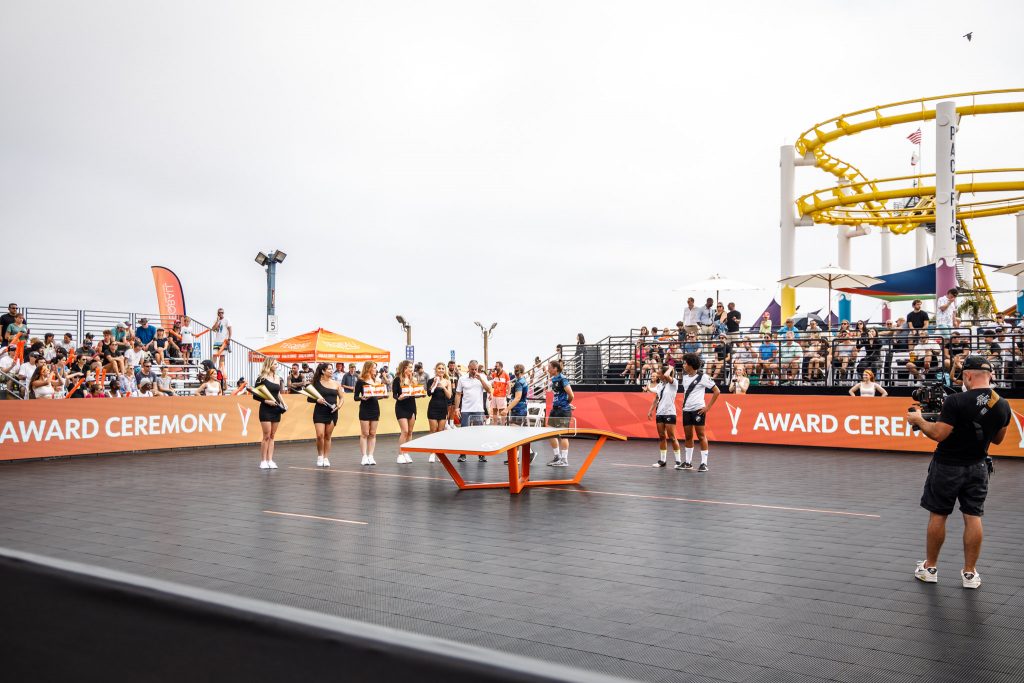 The world-famous West Coaster zoom sin the background of the Teqball court erected on the Santa Monica Pier behind Pacific Park.
