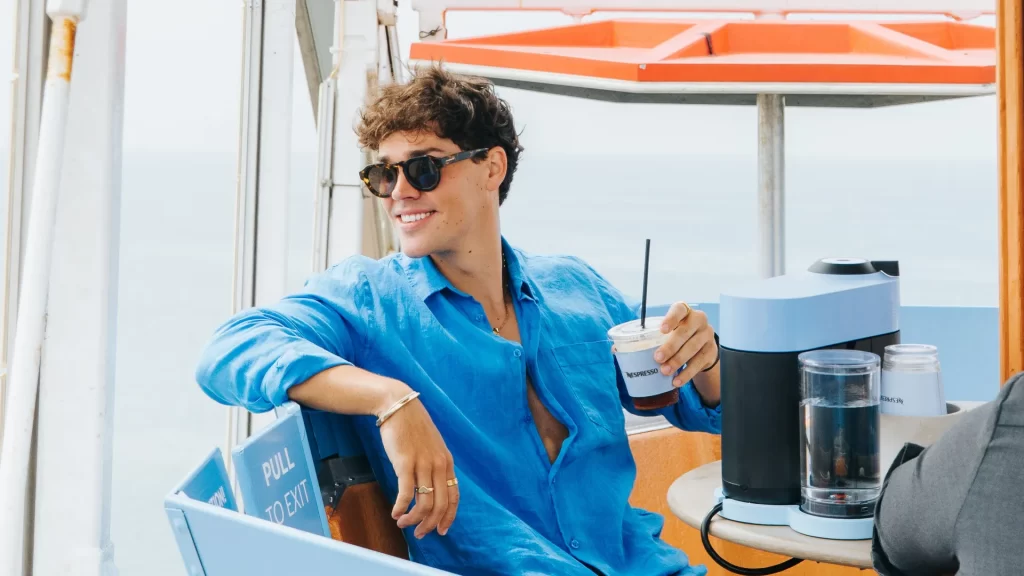 Noah Beck enjoying an iced coffee on the Pacific Wheel in Santa Monica | Photo courtesy of @nespresso