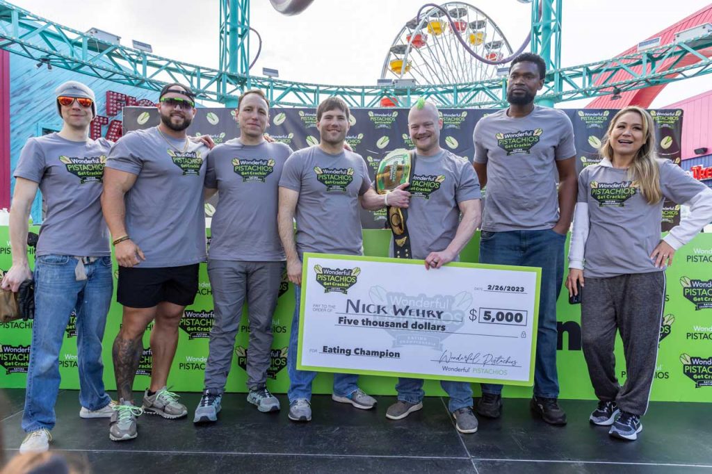 Competitive Eaters stand on the stage at Pacific Park on the Santa Monica Pier after the first annual Wonderful Pistachios Get Cracking Eating Competition.